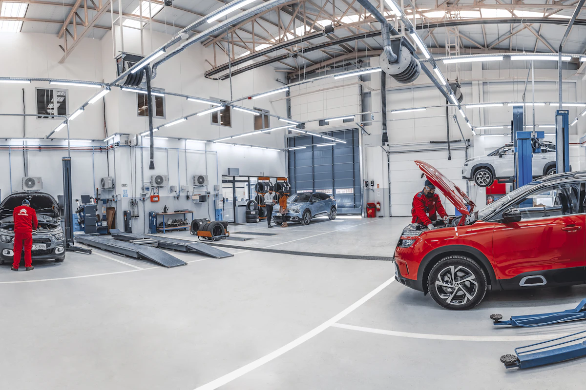 Mechanics servicing vehicles in an automotive workshop